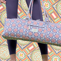 M44space-A yogi stands with a tote-style yoga bag in front of an oriental-inspired wall M44space-A yogi stands with a tote-style yoga bag in front of an oriental-inspired wall