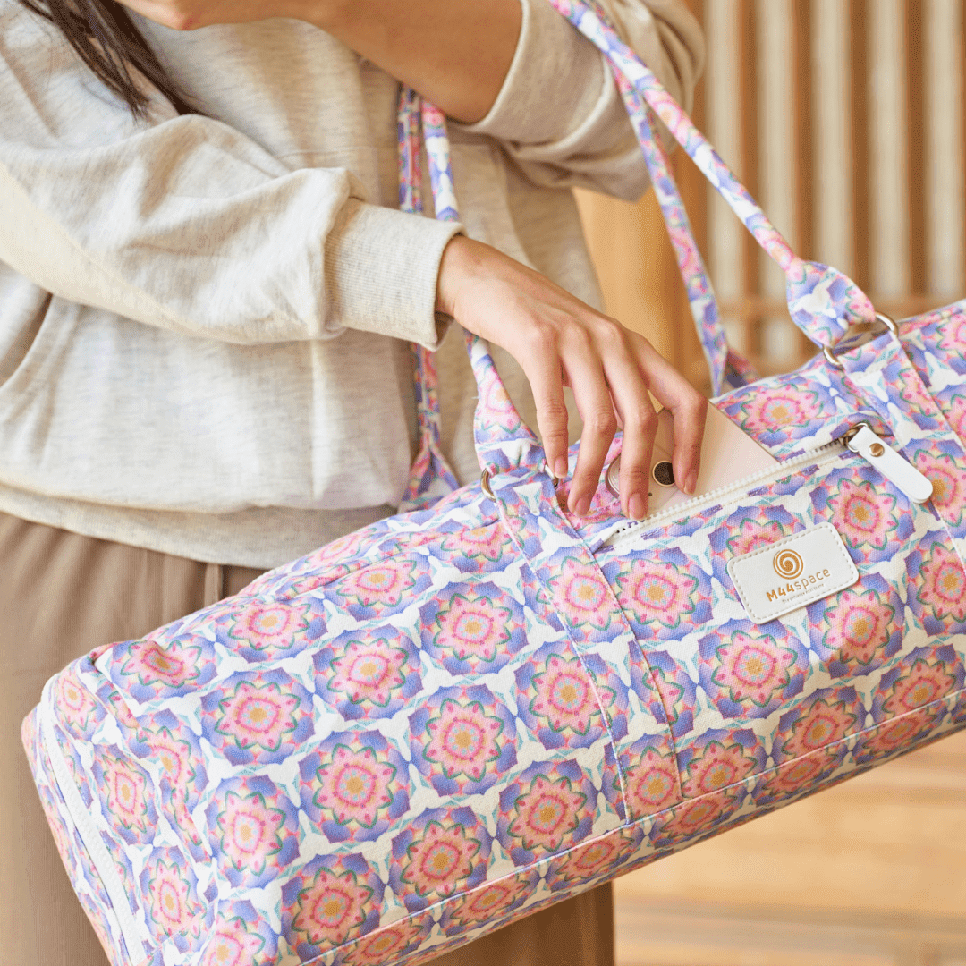 M44space-Yoga bag with front pocket for easy opening and closing, a woman removes her mobile phone from the front pocket of her yoga mat bag after leaving the yoga studio